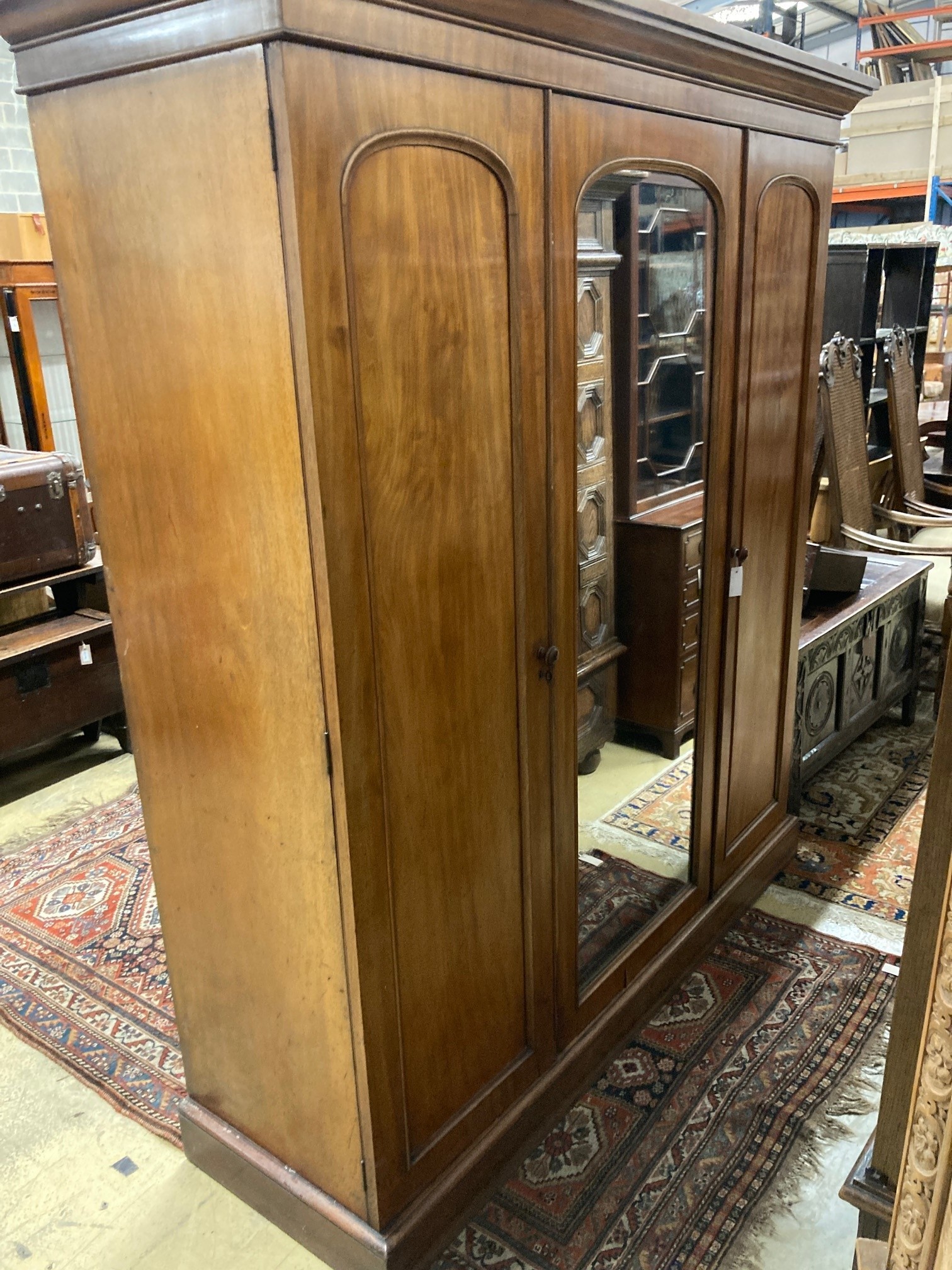 A Victorian mahogany triple mirrored wardrobe, bears Heals & Son brass plaque, width 190cm, depth 61cm, height 209cm